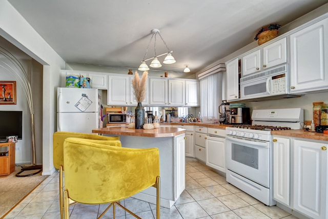 kitchen with a center island, white appliances, white cabinets, hanging light fixtures, and a breakfast bar area