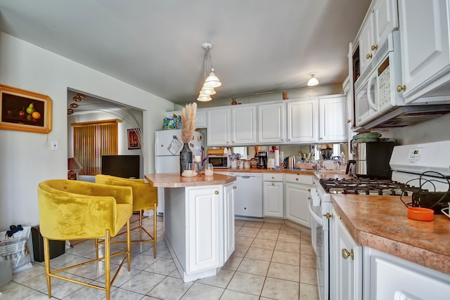 kitchen featuring a center island, hanging light fixtures, white cabinets, white appliances, and light tile patterned flooring