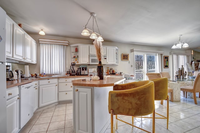 kitchen with a kitchen island, white cabinetry, and hanging light fixtures