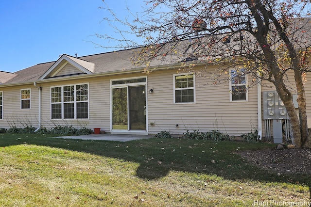 back of property featuring a yard and a patio area