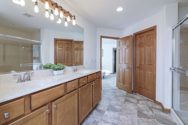 bathroom with vanity and a shower with shower door