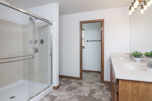 bathroom with vanity and a shower with shower door