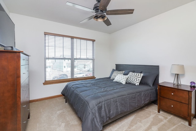 bedroom with ceiling fan and light carpet