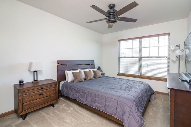 bedroom with ceiling fan and light colored carpet