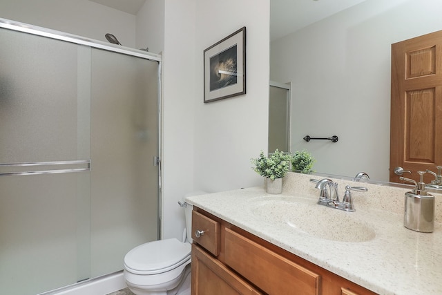 bathroom with vanity, toilet, and walk in shower