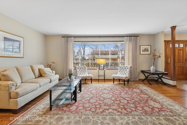 living room with hardwood / wood-style floors and decorative columns