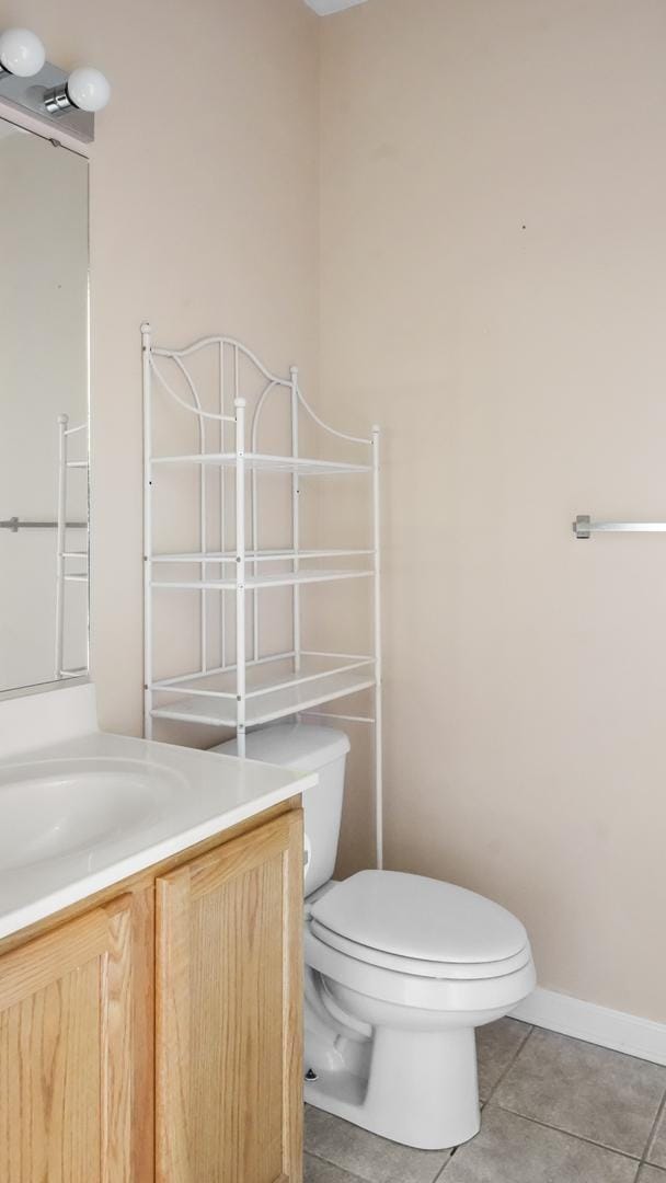 bathroom featuring tile patterned flooring, vanity, and toilet