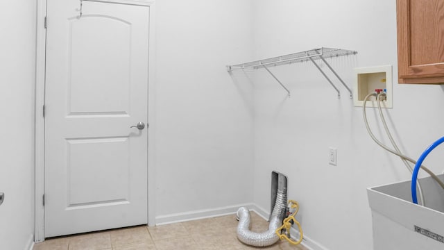 laundry room featuring electric dryer hookup, cabinets, sink, hookup for a washing machine, and light tile patterned floors