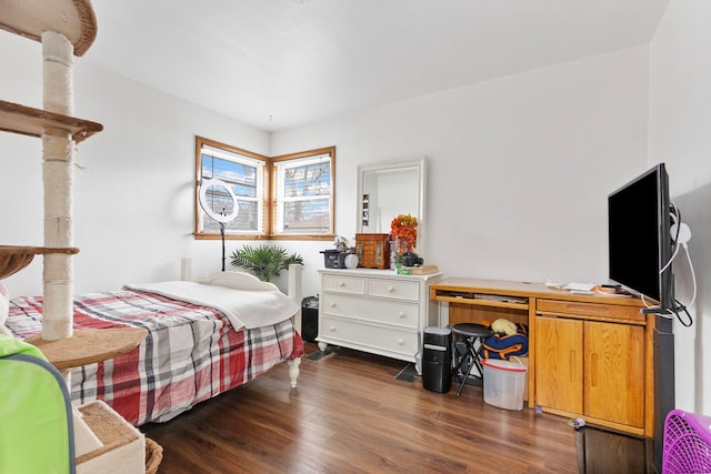 bedroom with dark hardwood / wood-style flooring