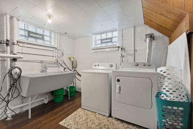 laundry area featuring hardwood / wood-style floors, independent washer and dryer, and sink