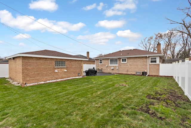 back of property featuring a lawn