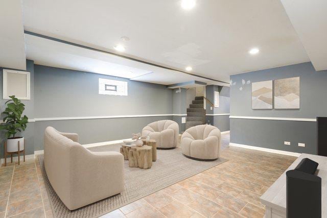 living area with recessed lighting, stairway, and baseboards