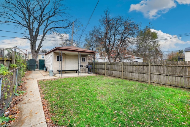 view of yard featuring a patio, an outbuilding, a fenced backyard, and a gate