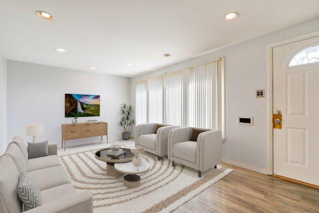 living room with recessed lighting, baseboards, and wood finished floors