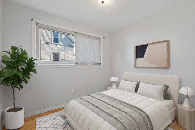 bedroom with light wood-type flooring and baseboards