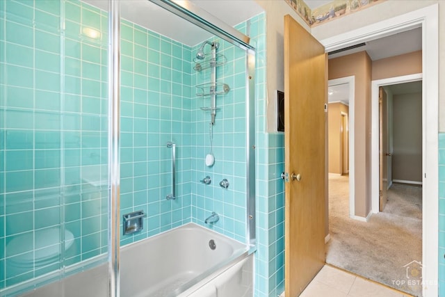 bathroom with tile patterned flooring and tiled shower / bath combo