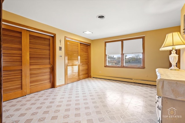 interior space featuring two closets and a baseboard radiator