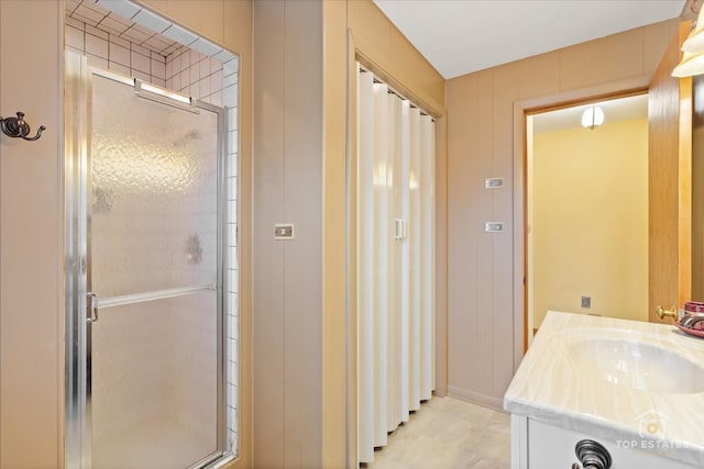 bathroom featuring vanity and an enclosed shower