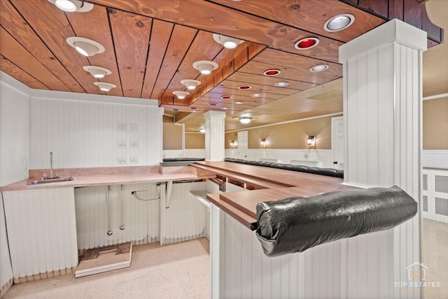 bar featuring white cabinetry, wood ceiling, and sink