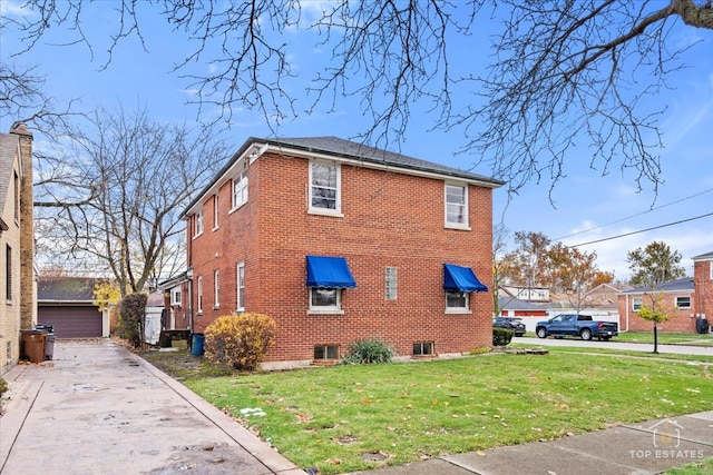 view of side of property with a yard and central AC