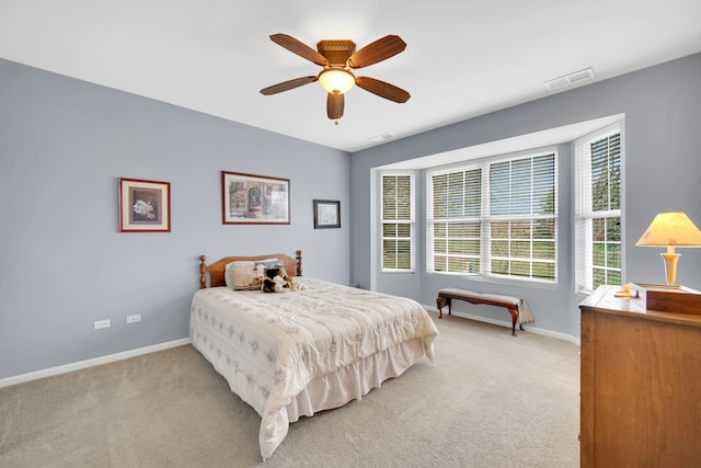 bedroom featuring light carpet and ceiling fan