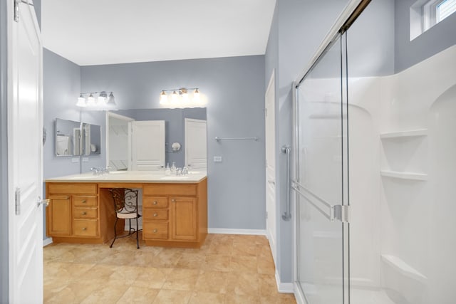 bathroom with vanity and a shower with shower door