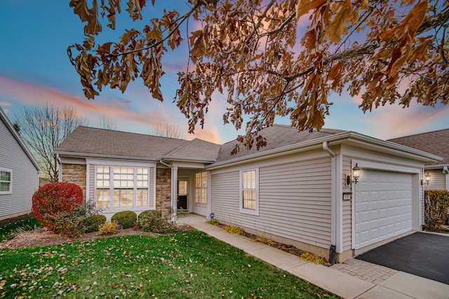 single story home with a yard and a garage