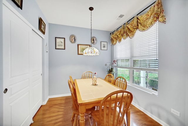 dining room with hardwood / wood-style flooring