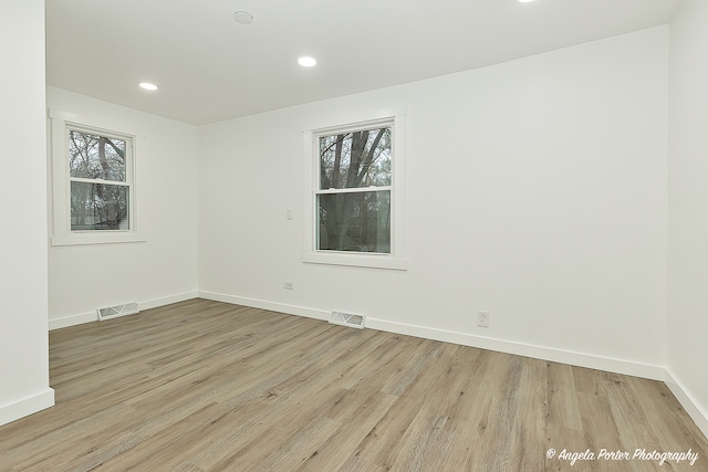 unfurnished room with light hardwood / wood-style floors