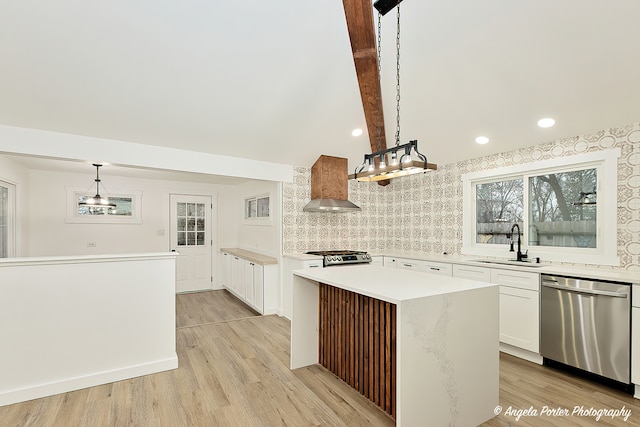 kitchen with a center island, light wood-type flooring, decorative light fixtures, white cabinetry, and stainless steel appliances