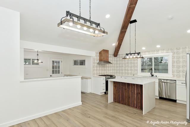 kitchen with white cabinetry, a center island, wall chimney exhaust hood, and stainless steel appliances