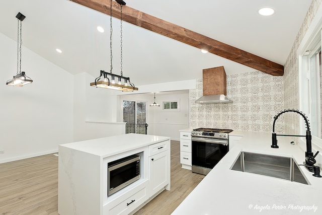 kitchen featuring sink, wall chimney exhaust hood, stainless steel appliances, vaulted ceiling with beams, and light hardwood / wood-style floors