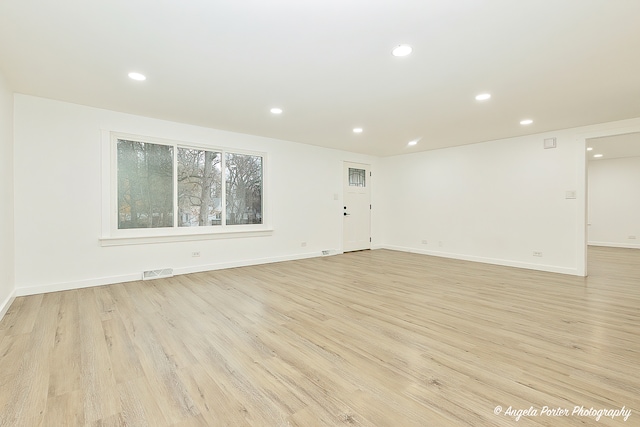 unfurnished room with light hardwood / wood-style flooring