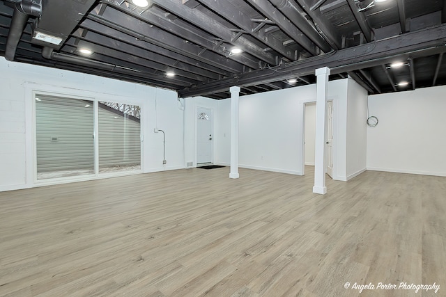 basement with light hardwood / wood-style flooring