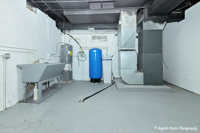 utility room featuring heating unit and water heater