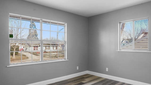 unfurnished room with dark wood-type flooring