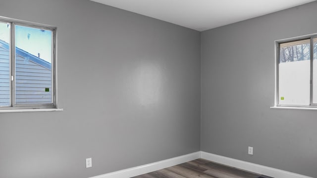 unfurnished room featuring dark hardwood / wood-style flooring