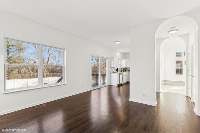 unfurnished living room featuring dark hardwood / wood-style flooring