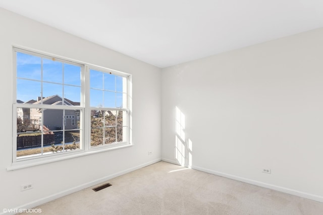 empty room featuring light carpet