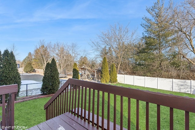 wooden deck with a lawn and a playground