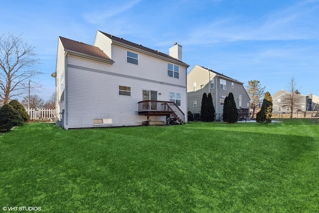 back of house with a wooden deck and a yard