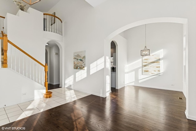 entrance foyer featuring hardwood / wood-style floors and a towering ceiling