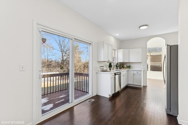 kitchen with dark hardwood / wood-style flooring, white cabinetry, sink, and appliances with stainless steel finishes