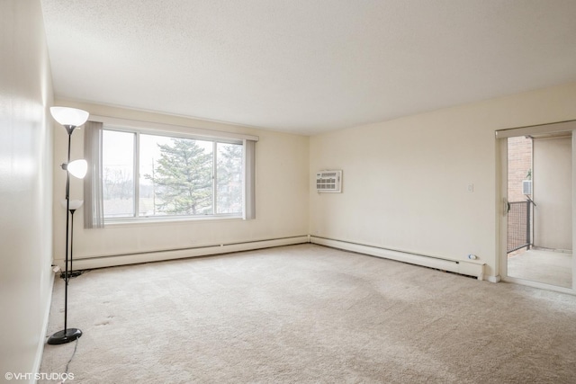 carpeted empty room with a wall mounted air conditioner and a textured ceiling