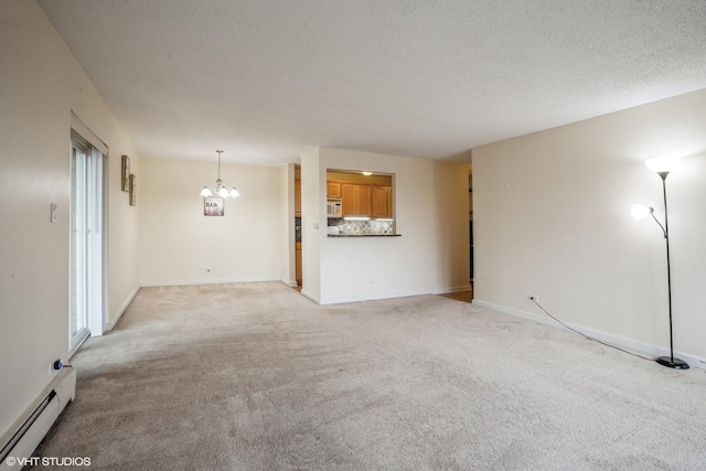 unfurnished living room featuring light carpet, a baseboard radiator, a textured ceiling, and an inviting chandelier