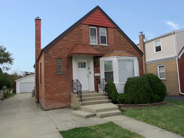 view of front facade with an outbuilding and a garage