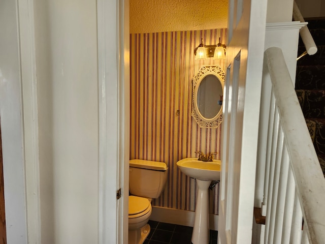 bathroom featuring tile patterned floors, sink, and toilet