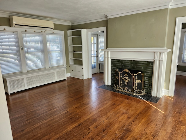 unfurnished living room featuring a wall unit AC, dark hardwood / wood-style flooring, radiator heating unit, and ornamental molding