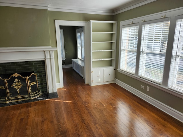 unfurnished living room featuring dark hardwood / wood-style floors, radiator, and ornamental molding