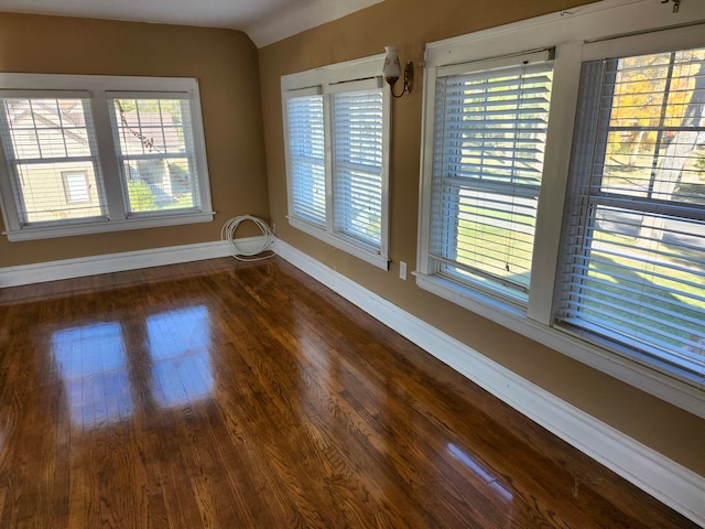 spare room with dark wood-type flooring and a baseboard radiator